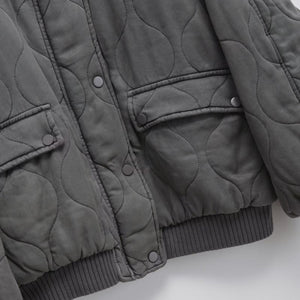 Quilted gray jacket on a light gray background
