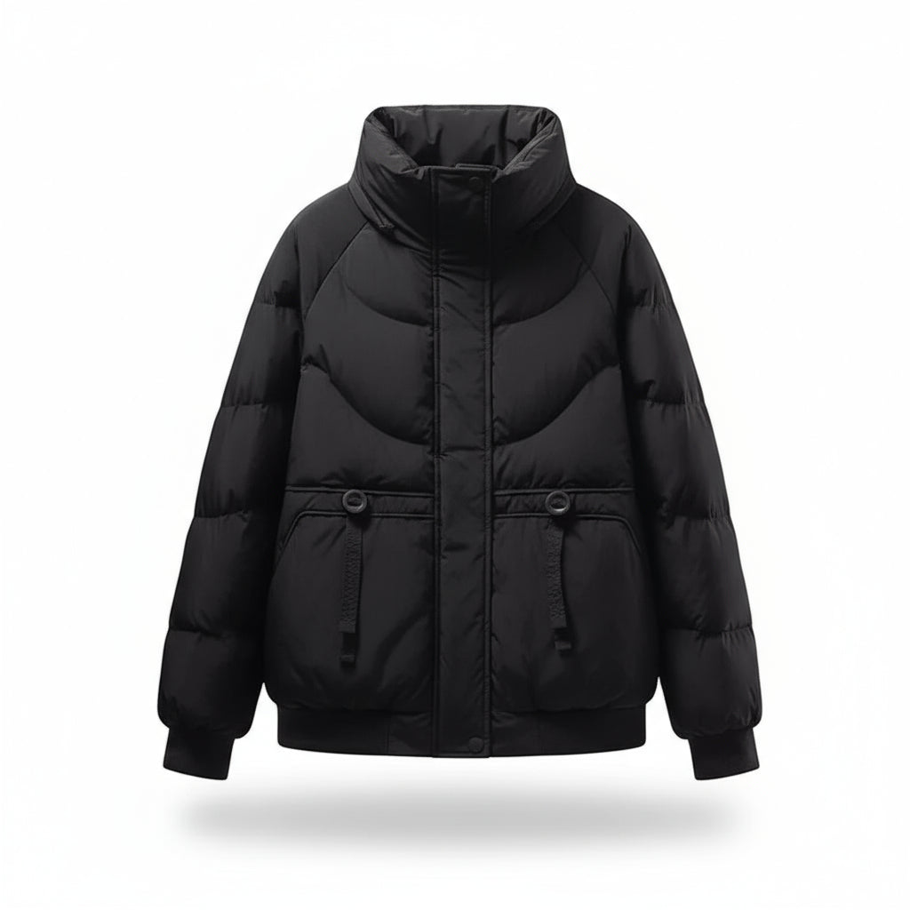 Black puffer jacket on a mannequin with a beige sweater underneath against a beige background