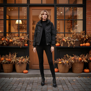 Woman in black outfit standing in front of a store with Halloween decorations