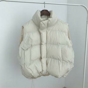 White puffer vest hanging on a rack against a white background