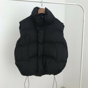 Black puffer vest on a hanger against a white background