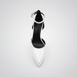 Black high-heeled shoe with a white sole on a light gray background