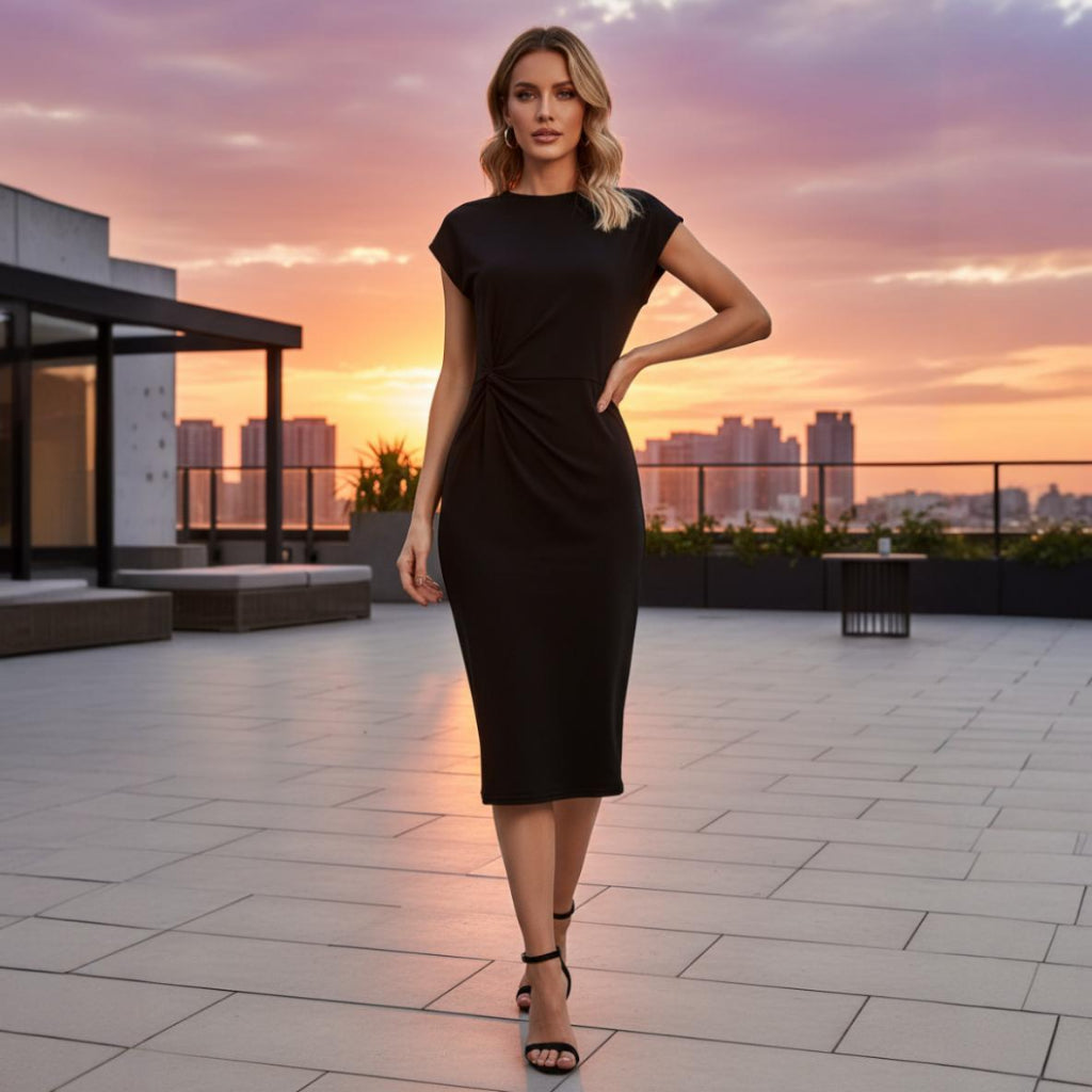 Woman in a black dress standing on a rooftop with a cityscape and sunset in the background