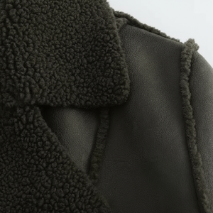 Close-up of a dark green textured fabric with a soft texture.