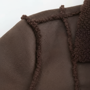 Close-up of brown fleece fabric with tassels on a white background