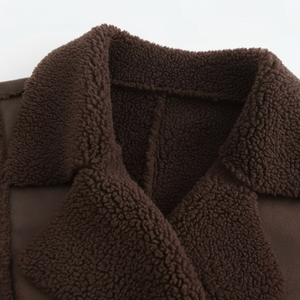 Close-up of a brown sherpa-lined jacket with a white background