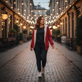 Woman walking down a street with string lights on buildings
