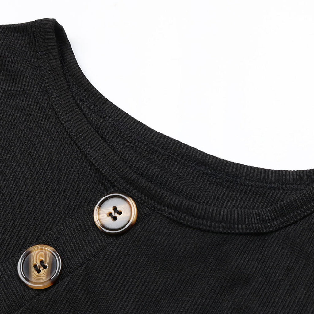 Close-up of a black garment with two buttons on a white background