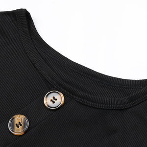 Close-up of a black garment with two buttons on a white background