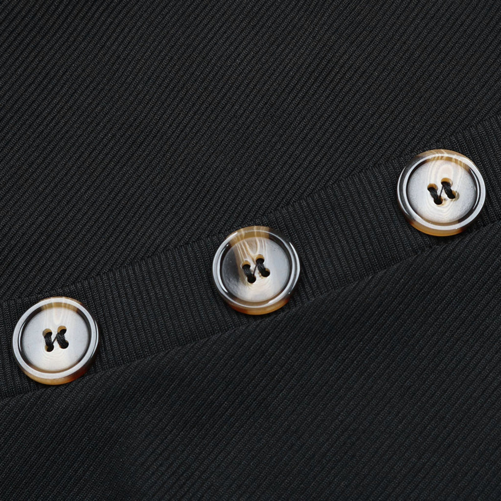 Close-up of four buttons on a black textured fabric background