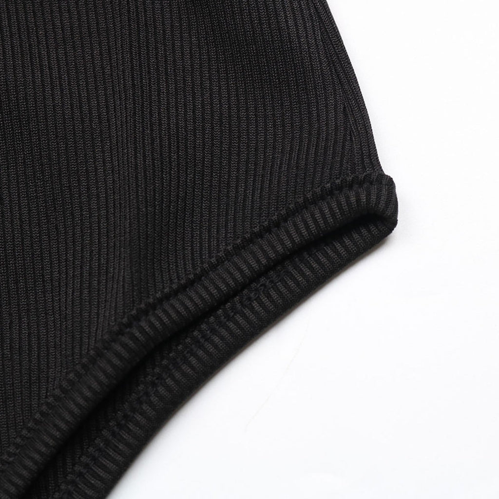 Close-up of a black ribbed knit fabric on a white background