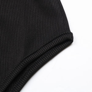 Close-up of a black ribbed knit fabric on a white background