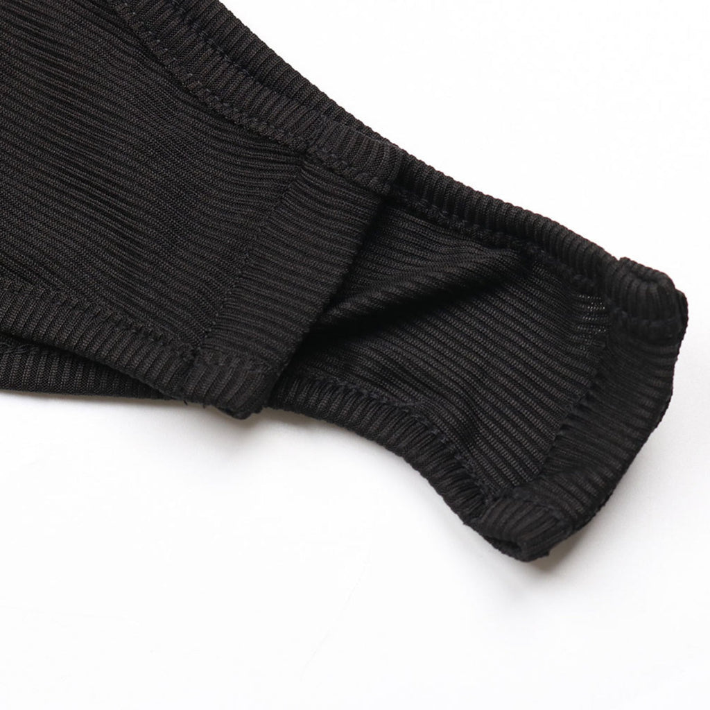 Close-up of black ribbed socks on a white background