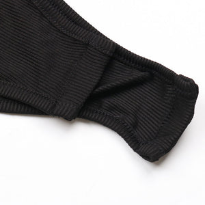 Close-up of black ribbed socks on a white background