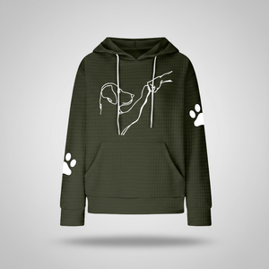 Green hoodie with white dog design on a light gray background