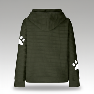 Green hoodie with white paw prints on sleeves against a gray background