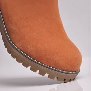 Close-up of a brown boot with a white background