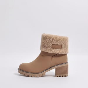 Tan ankle boot with shearling collar on a light gray background