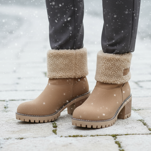 Tan winter boots with fur-lined cuffs on a snowy ground