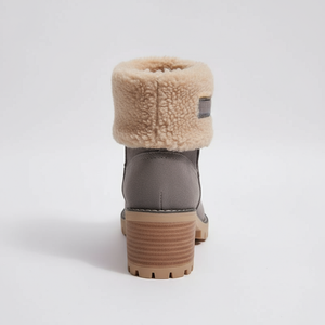 Gray winter boot with beige fur lining on a light gray background