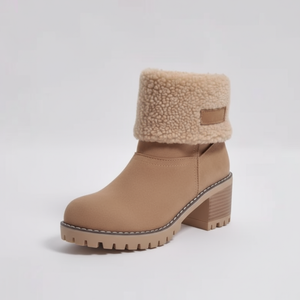 Tan ankle boot with shearling collar on a light gray background