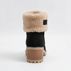 Black boot with beige shearling lining on a white background