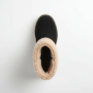 Black boot with beige fuzzy trim on a white background