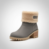 Gray ankle boot with beige fur lining on a white background