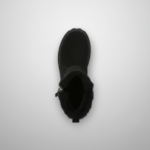 Black boot with fur lining on a light gray background
