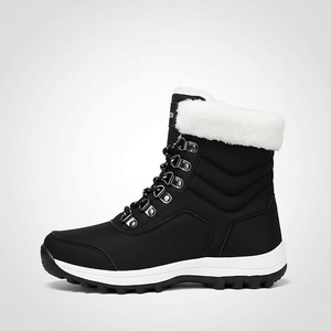 Black winter boot with white fur lining on a light gray background