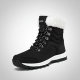 Black winter boot with white fur lining on a gray background