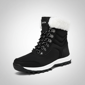 Black winter boot with white fur lining on a gray background
