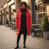 Person wearing a red puffer coat standing on a street with buildings and tables in the background.
