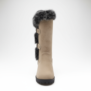 Beige boot with black fur trim on a white background