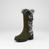 Green knee-high boot with fur trim on a white background