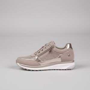 Beige sneaker on a gray background