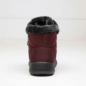 Maroon winter boot with gray fur lining on a white background