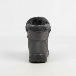 Gray winter boot with fur lining on a white background