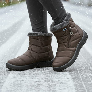Brown winter boots with fur lining worn on a snowy ground