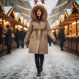 Person wearing a brown coat with a fur hood in a festive outdoor setting