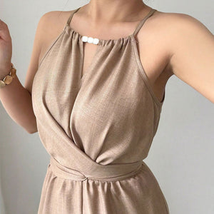 Beige jumpsuit worn by a person against a plain background