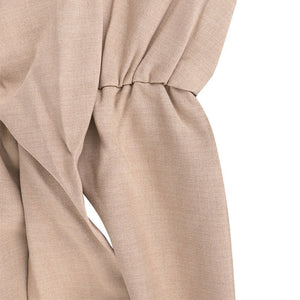 Close-up of beige fabric with a knot on a white background