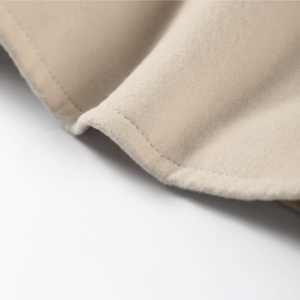 Close-up of beige fabric with a white background