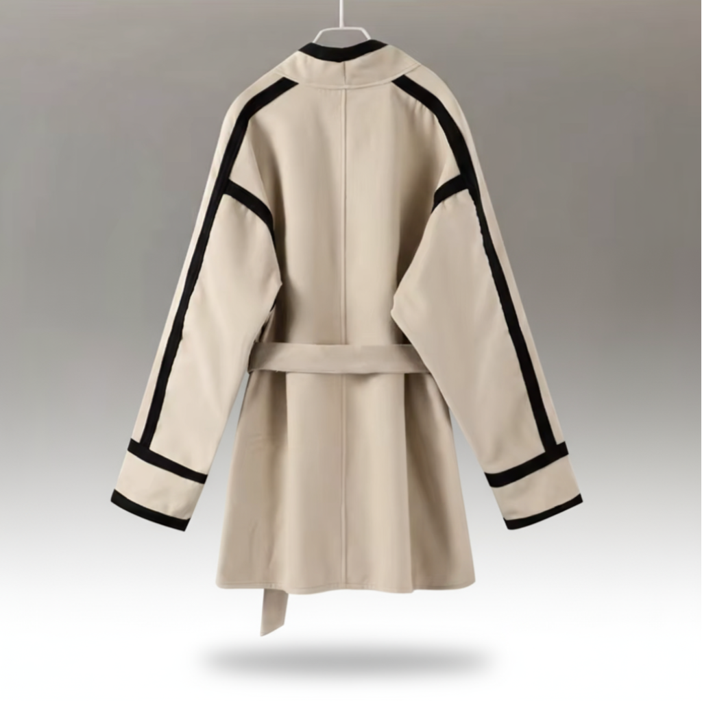 Beige coat with black accents on a gray background