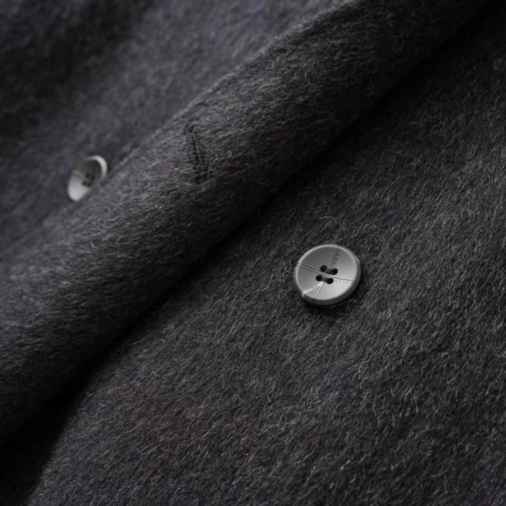 Close-up of dark gray fabric with buttons