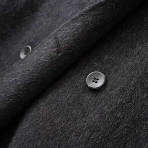 Close-up of dark gray fabric with buttons